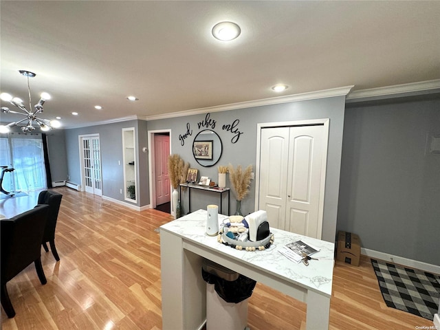 kitchen with crown molding, light hardwood / wood-style flooring, a baseboard heating unit, and a notable chandelier