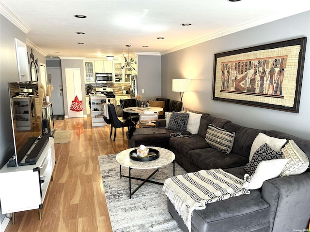 living room with light hardwood / wood-style floors and ornamental molding