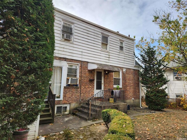 27 Allen St, Hempstead, NY 11550 - view of property featuring brick siding and cooling unit
