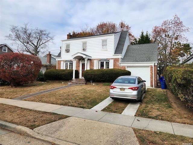 view of front of house featuring a garage and a front lawn