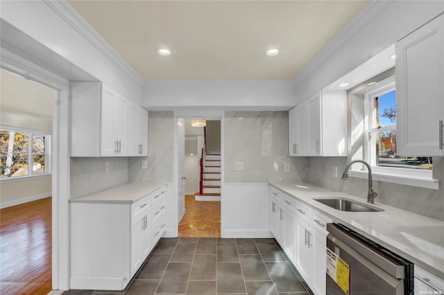 kitchen featuring white cabinetry, stainless steel dishwasher, and sink