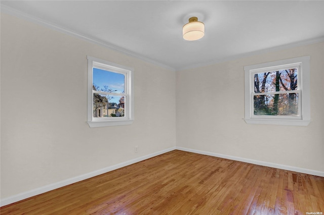 spare room with hardwood / wood-style flooring and ornamental molding