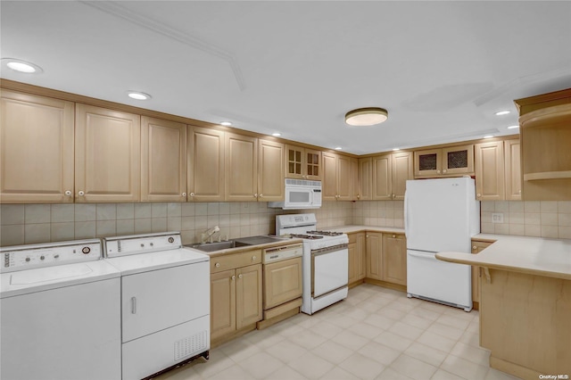 kitchen featuring independent washer and dryer, white appliances, light brown cabinetry, and sink