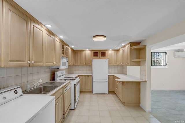 kitchen featuring a wall mounted air conditioner, white appliances, sink, light brown cabinetry, and washer / dryer