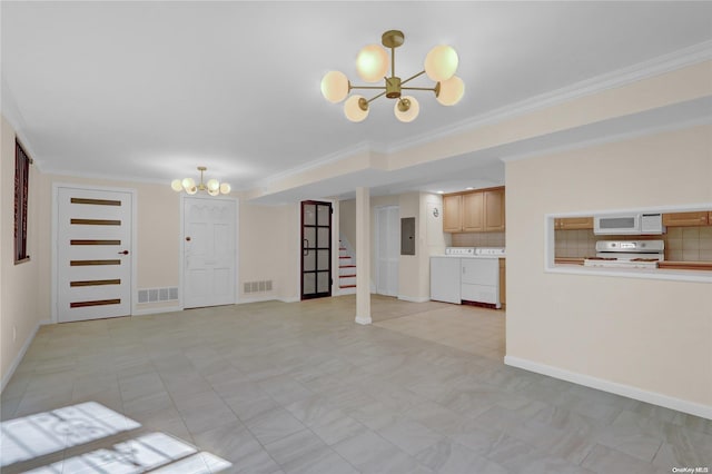 unfurnished living room with washer and dryer, ornamental molding, electric panel, and a notable chandelier