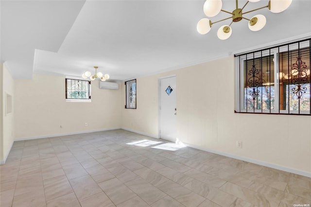 spare room with a notable chandelier and a wall unit AC