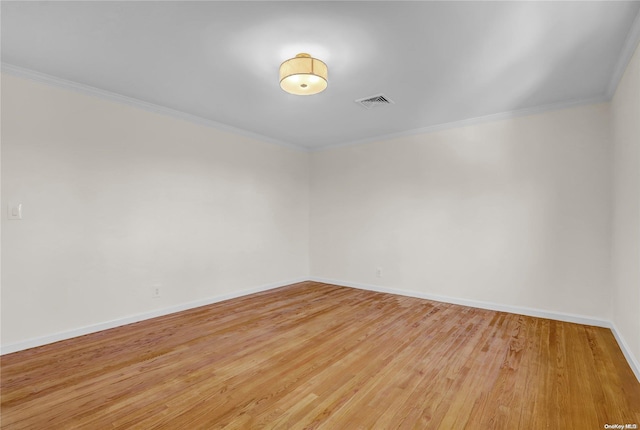 unfurnished room featuring light hardwood / wood-style floors and ornamental molding