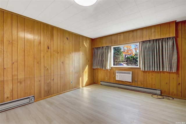 empty room featuring light wood-type flooring, a wall unit AC, a baseboard heating unit, and wood walls