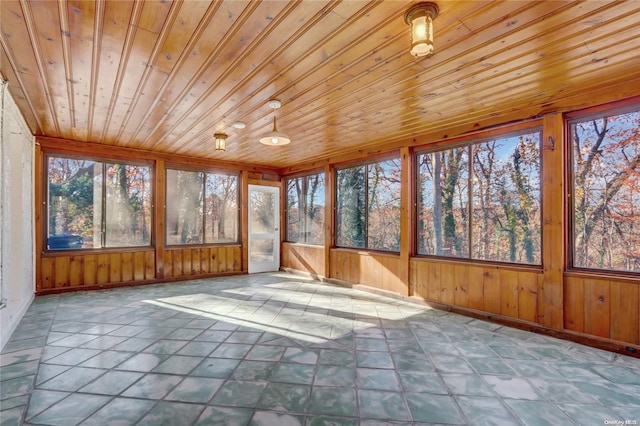 unfurnished sunroom featuring wooden ceiling and a healthy amount of sunlight