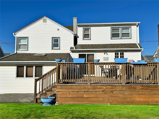 rear view of property featuring a wooden deck