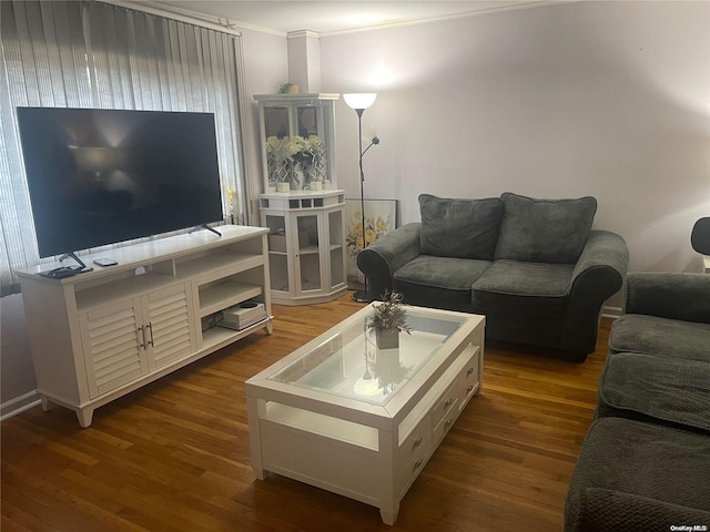 living room with ornamental molding and dark wood-type flooring