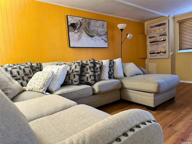 living room featuring wood-type flooring and crown molding