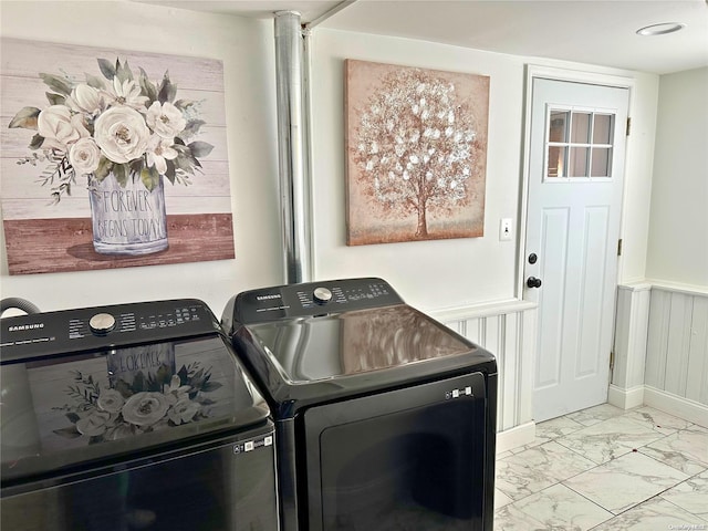 clothes washing area with washing machine and dryer