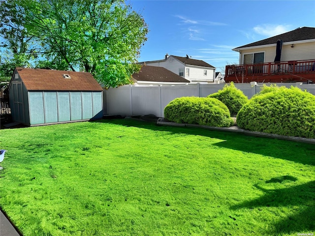 view of yard featuring a shed and a deck