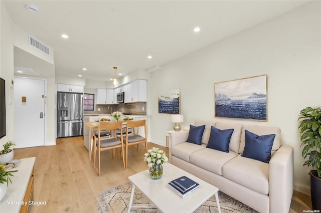 living room with light hardwood / wood-style flooring