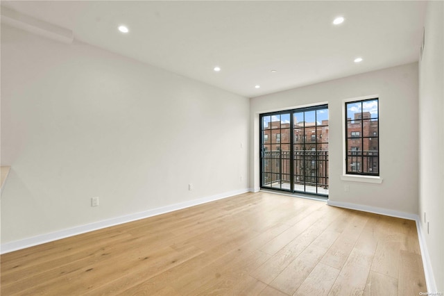 empty room with light hardwood / wood-style floors