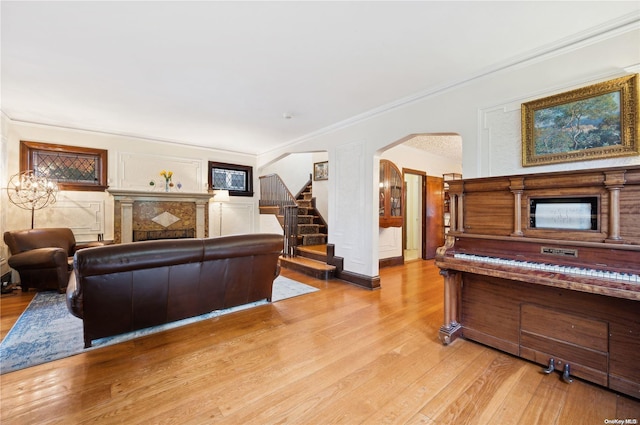 living room with light hardwood / wood-style flooring and crown molding