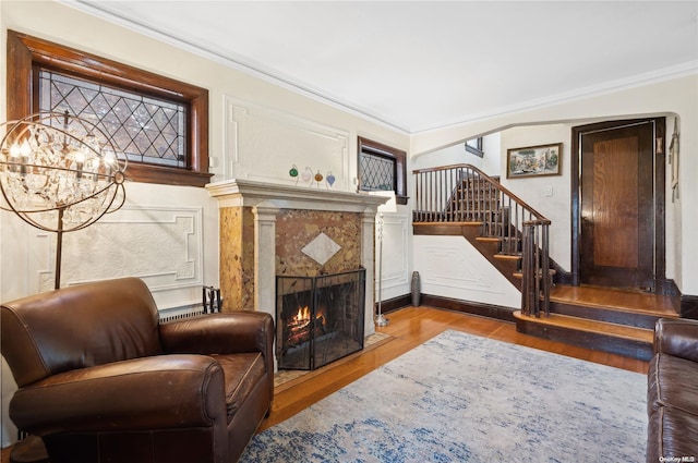 living room with hardwood / wood-style floors and ornamental molding