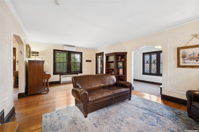 living room featuring hardwood / wood-style flooring and ornamental molding