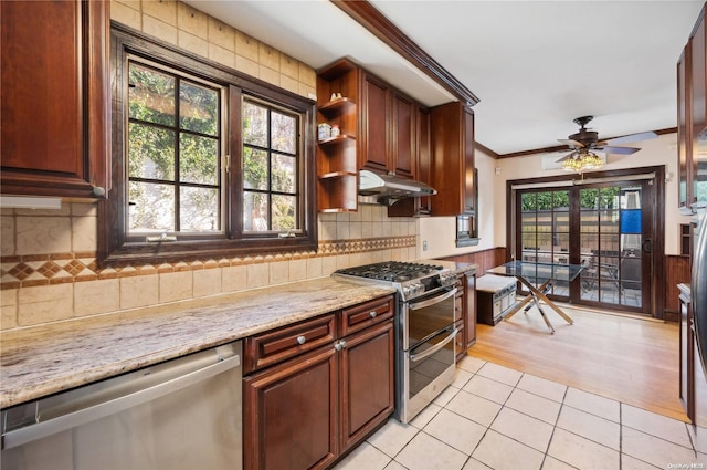 kitchen featuring appliances with stainless steel finishes, light stone counters, ceiling fan, crown molding, and light hardwood / wood-style flooring