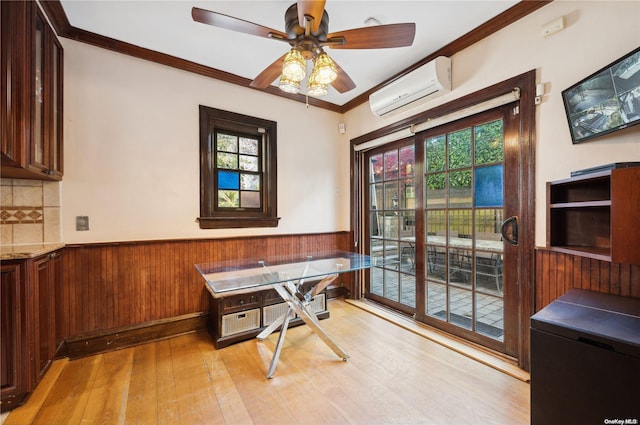 office with a wall mounted air conditioner, a healthy amount of sunlight, light wood-type flooring, and ornamental molding