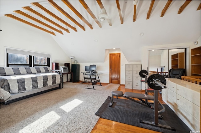 bedroom with wood-type flooring, high vaulted ceiling, and a closet