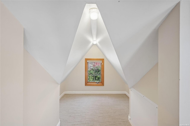 bonus room featuring light carpet and lofted ceiling