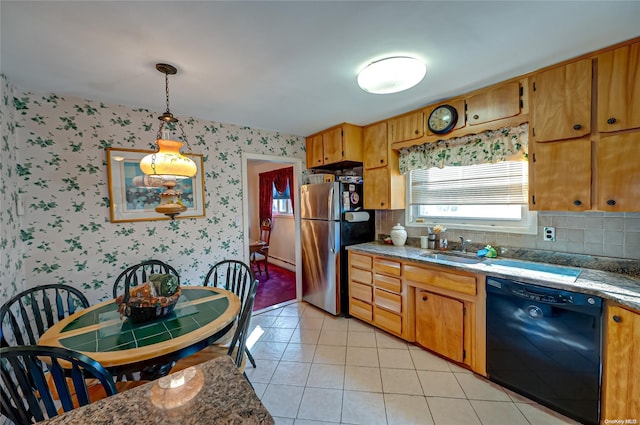 kitchen featuring stainless steel refrigerator, dishwasher, sink, decorative light fixtures, and light tile patterned floors