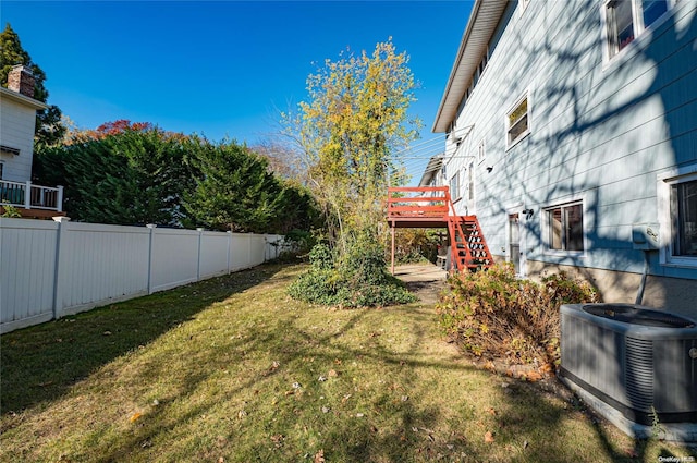 view of yard with cooling unit and a wooden deck