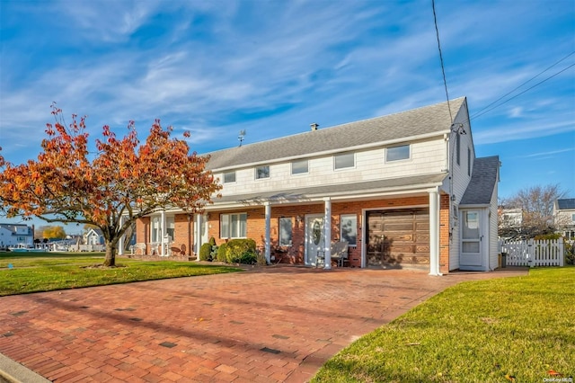 view of front of property featuring a garage and a front lawn