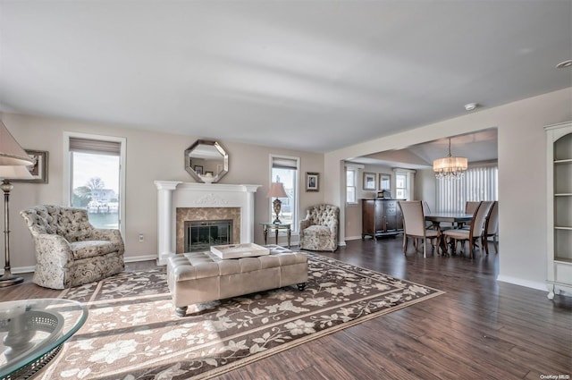 living room with dark hardwood / wood-style floors and an inviting chandelier