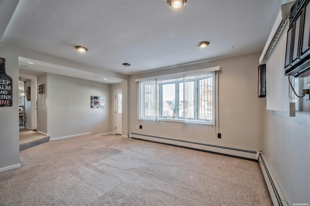 carpeted spare room with a baseboard radiator