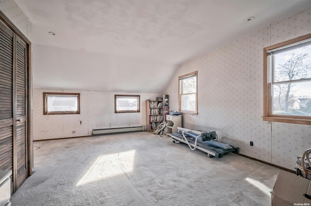 exercise room featuring baseboard heating, light carpet, and lofted ceiling