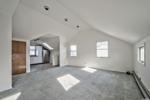 additional living space with carpet floors, baseboard heating, and lofted ceiling