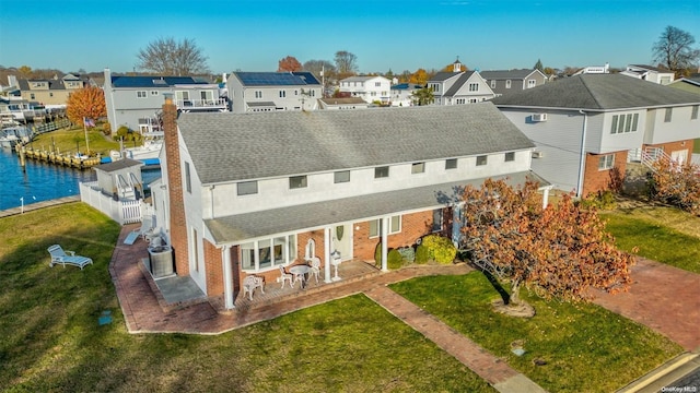 1 Jetmore Pl, Massapequa, NY 11758 - rear view of property featuring a residential view, roof with shingles, brick siding, and a patio area
