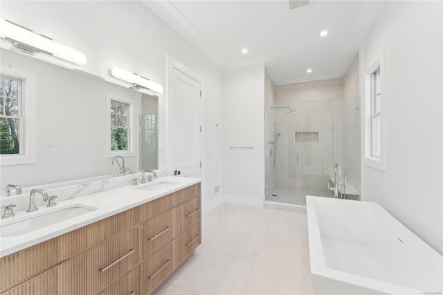 bathroom featuring plus walk in shower, vanity, and crown molding