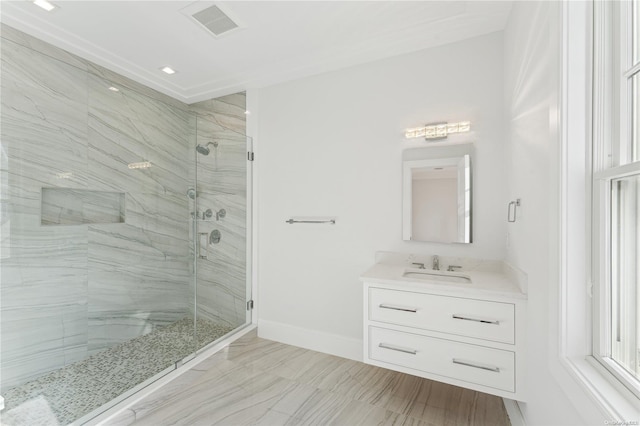 bathroom with vanity and a shower with shower door