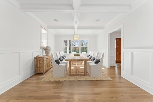 unfurnished dining area featuring crown molding, beamed ceiling, coffered ceiling, and light wood-type flooring