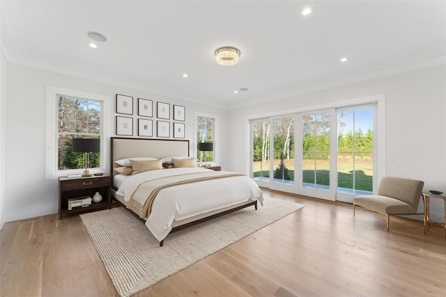 bedroom with access to exterior, light hardwood / wood-style flooring, and ornamental molding