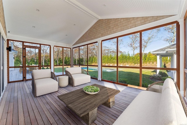 sunroom / solarium featuring lofted ceiling with beams and a wealth of natural light