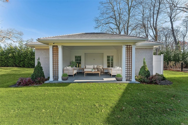 rear view of property featuring a lawn and an outdoor living space