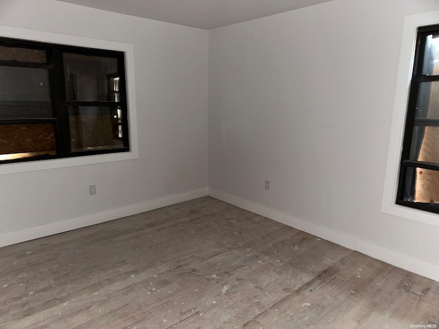 unfurnished room featuring hardwood / wood-style floors