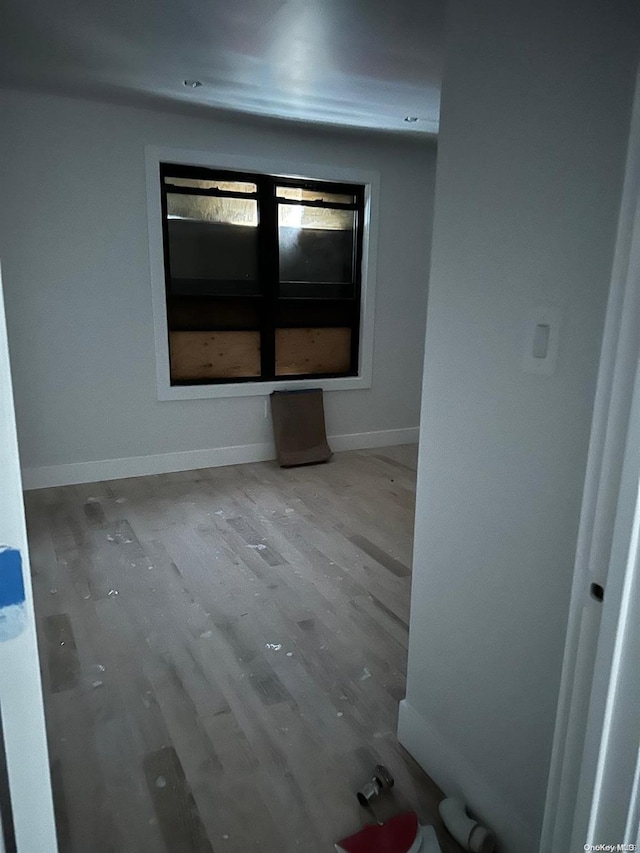 unfurnished room with hardwood / wood-style floors