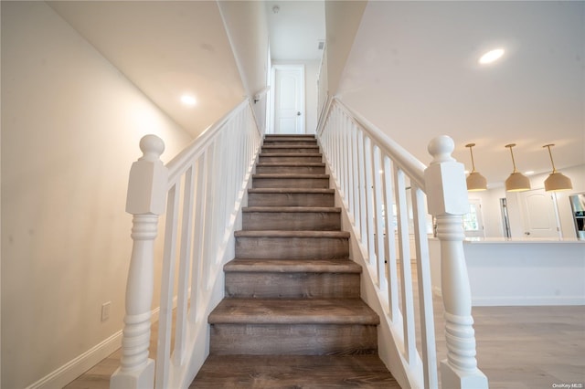 staircase with hardwood / wood-style flooring