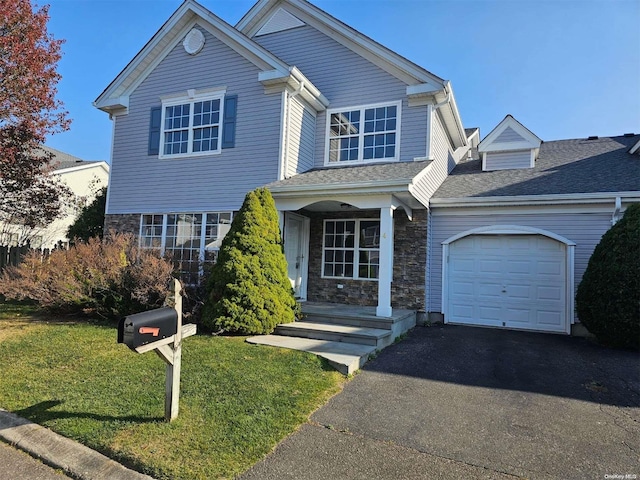 front of property featuring a garage and a front lawn