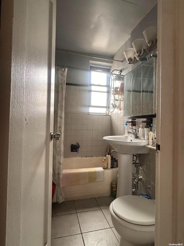 bathroom with toilet, shower / bath combo, and tile patterned floors