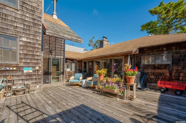 wooden terrace featuring a grill