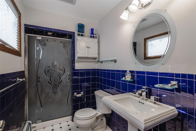 bathroom with a shower, toilet, tile walls, and sink