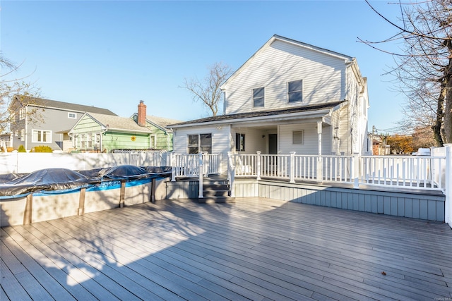 wooden deck with a covered pool