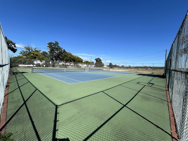 view of sport court with basketball hoop